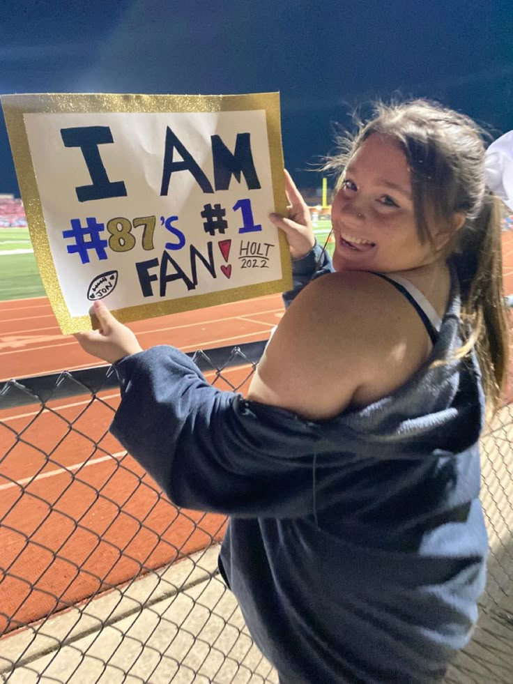 a woman holding up a sign that says i am 80's fan