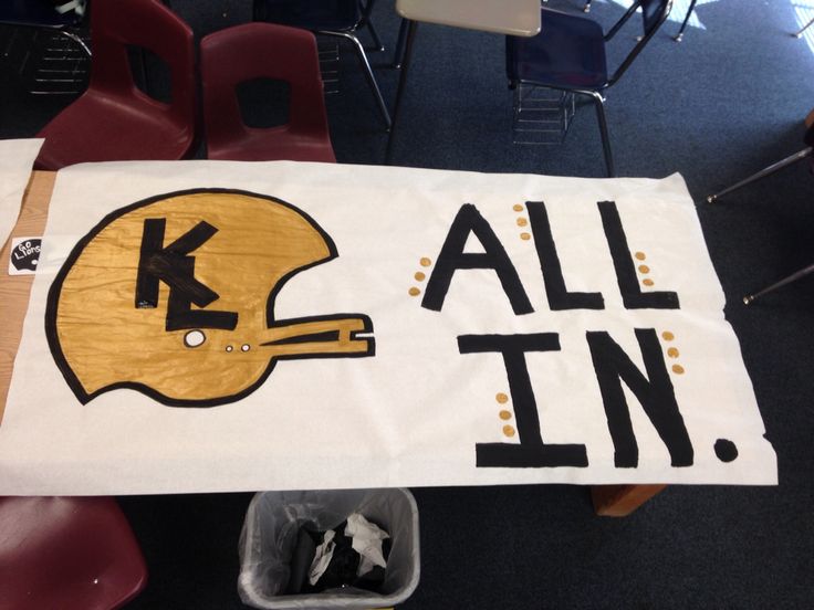 a table with a football helmet on it and the words k all in painted on it