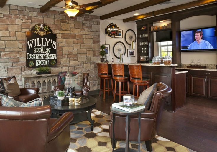 a living room filled with furniture and a flat screen tv mounted on the wall above a bar