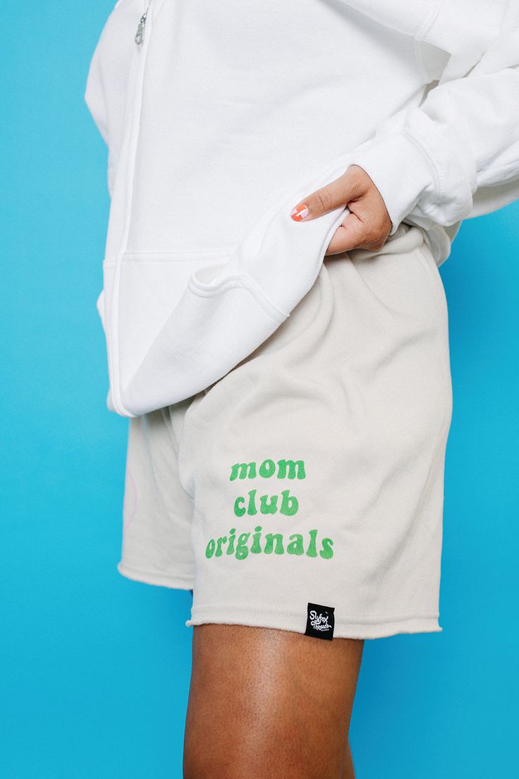 Mom Club Original Sweatshirts with a happy face :) This soft, drawstring short features raw edges and a relaxed fit that hits above the knee for chill vibes. Also available in Black! Features: Raw Edge Hem, Relaxed Fit, Longer Length Fabrication: 52% Airlume combed and ring-spun cotton, 48% polyester fleece, 32 single, 7.0oz. Casual Graphic Print Shorts With Relaxed Fit, Casual Relaxed Fit Shorts With Graphic Print, Casual Graphic Print Relaxed Fit Shorts, Cozy Cotton Leisure Shorts, Cotton Relaxed Fit Shorts With Letter Print, Relaxed Fit Comfortable Shorts For Streetwear, Comfortable Relaxed Fit Shorts For Streetwear, Trendy Graphic Print Loungewear Shorts, Trendy Graphic Print Shorts For Loungewear