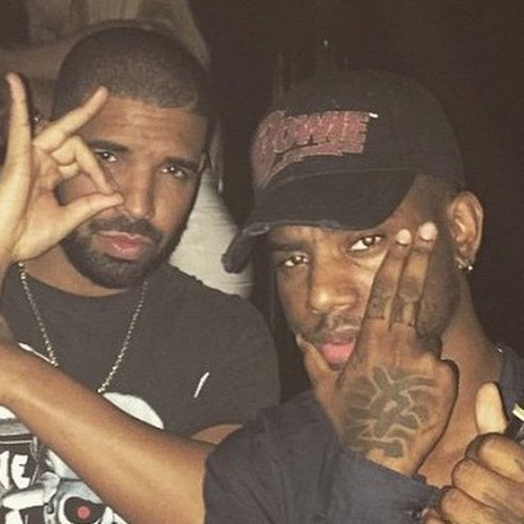 two men are posing for the camera with their hands in front of them and one is holding his face up