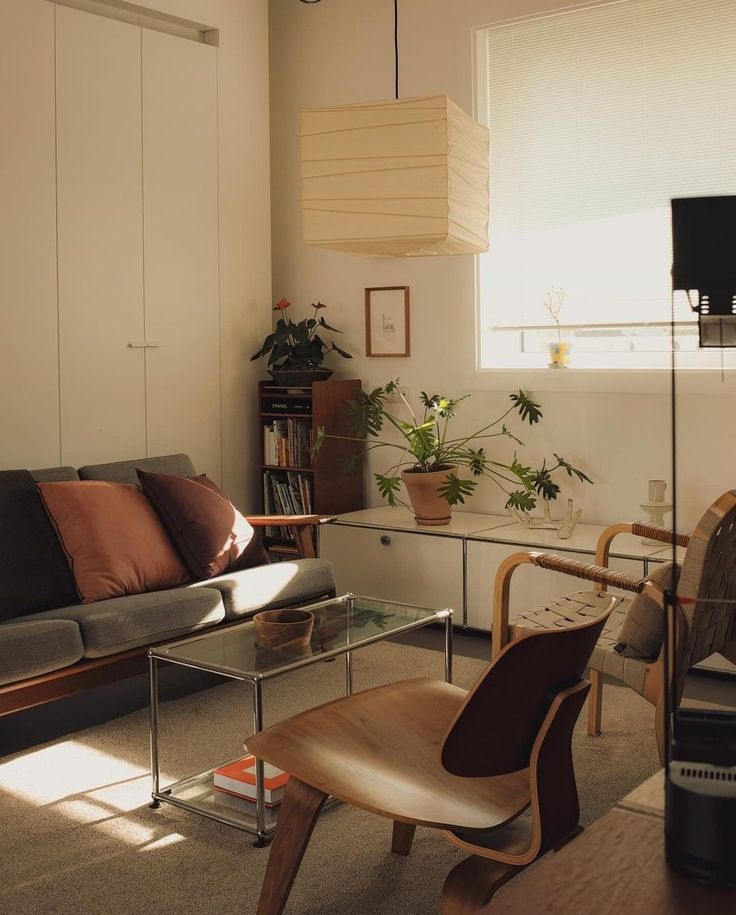 a living room filled with furniture and a flat screen tv on top of a wooden table