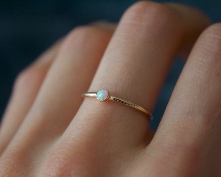 Handmade 3mm white opal 14k gold filled band ring✨🌚 Dainty and perfect minimalist piece! Stunning 3mm lab grown opal gemstones. Each stone is hand set into a bezel and polished for a beautiful shine finish. Opal means jewel. The energies of this stone will also encourage you to express your true self, in addition to feeling confident and comfortable in your own skin, and this will radiate in your words, thoughts, and actions. Material: 14/20 (karat/purity) gold filled Or solid 925 Sterling silv Everyday 14k Gold Opal Ring, Handmade Minimalist Opal Promise Ring, Minimalist Handmade Opal Promise Ring, Minimalist 14k Gold Opal Promise Ring, Minimalist Opal Birthstone Ring, Minimalist Opal Stackable Promise Rings, Delicate 14k Gold Opal Ring Gift, Minimalist Gold Opal Birthstone Ring, Minimalist Stackable Opal Ring