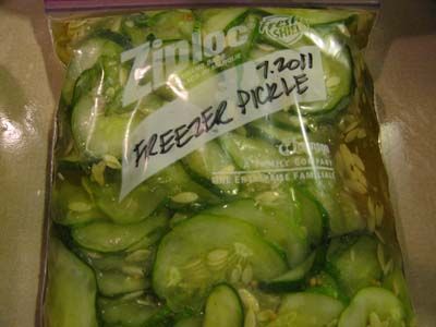 a bag filled with sliced cucumbers sitting on top of a counter