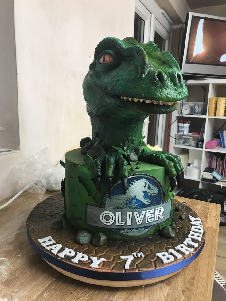 a birthday cake made to look like a dinosaur