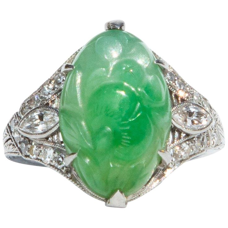 A beautiful jade and diamond ring from the Art Deco era. This rind boasts a large hand-carved jade flanked decadent diamond encrusted shoulders, set in platinum. Total diamond weight certified 0.7 carats, H colour and SI-1. The carved Jade is fifteen by ten millimetres. Ring size N or 7. Certification included White Gold Diamond Band, Vintage Cocktail Ring, Gold Diamond Band, Real Gold Jewelry, Carved Jade, Platinum Diamond Rings, Fine Diamond Jewelry, Ring Art Deco, Buying Diamonds