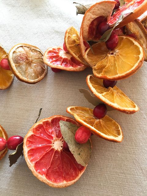 oranges and cherries cut in half on a table