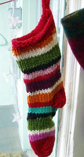 a knitted stocking hanging from a door