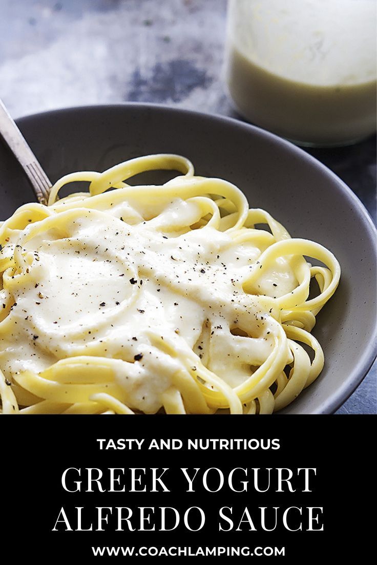 a bowl filled with noodles and sauce next to a glass of milk on a table