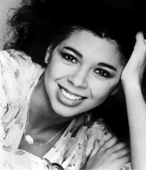 a black and white photo of a woman smiling