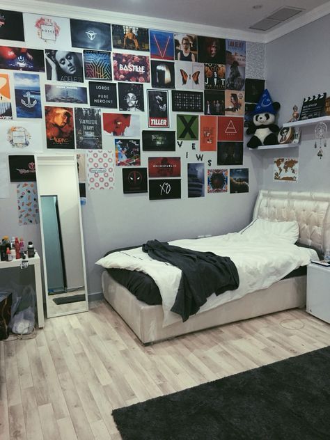 a bed room with a neatly made bed and lots of pictures on the wall