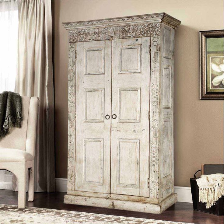 an old white armoire in a living room