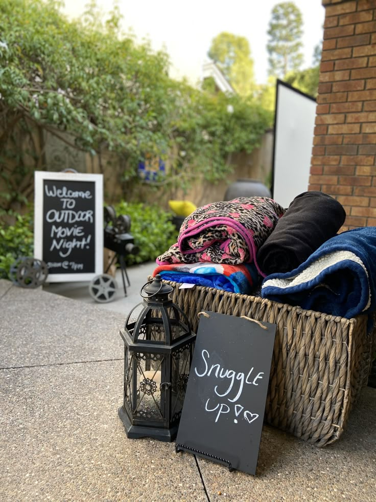 a basket filled with blankets next to a sign