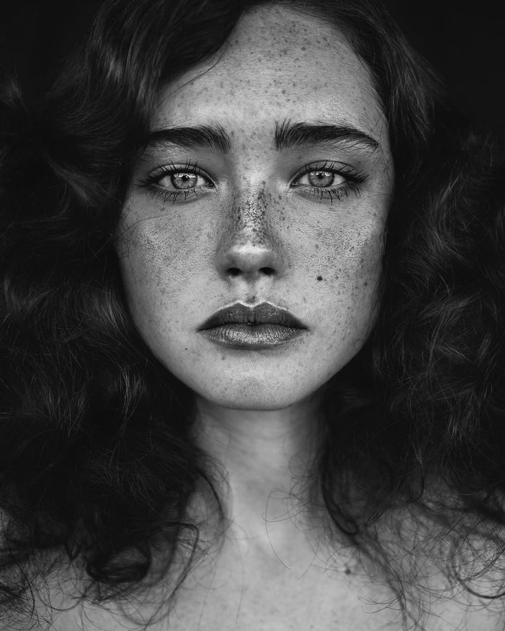 a woman with freckles on her face is shown in this black and white photo