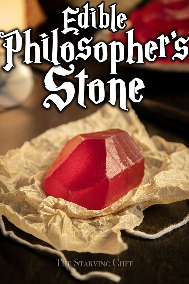 the cover of edible philospher's stone, with an image of a red rock on parchment paper