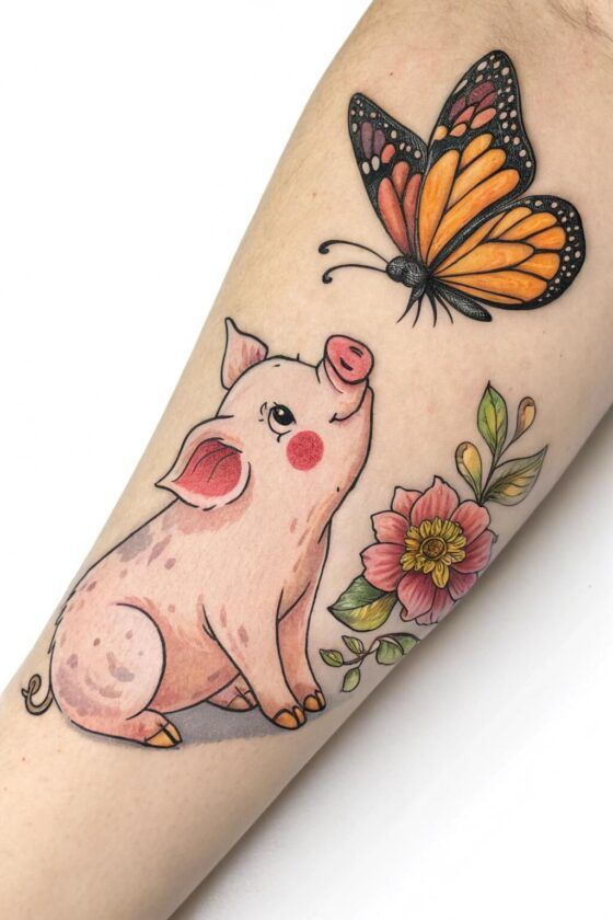 a pig and butterfly tattoo on the arm