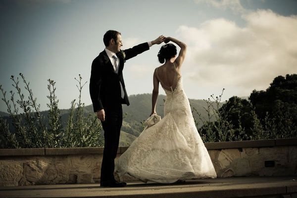 the bride and groom are posing for pictures