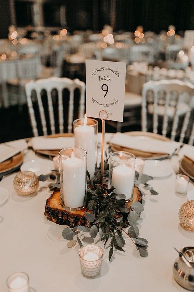 the table is set with candles and place cards