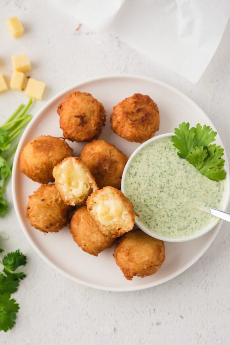 a white plate topped with tater tots and dip