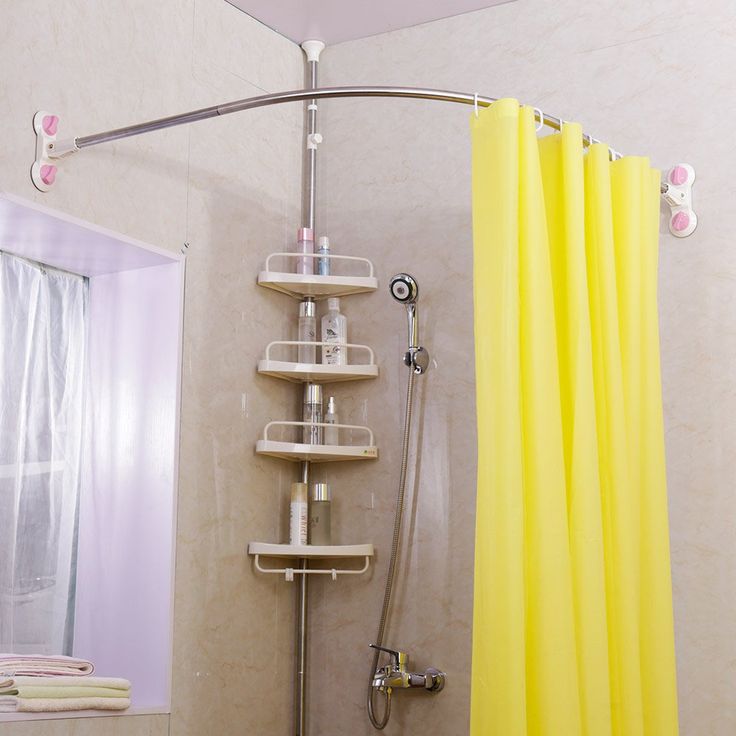 a bathroom with yellow shower curtain and shelving unit in the corner, next to a white toilet