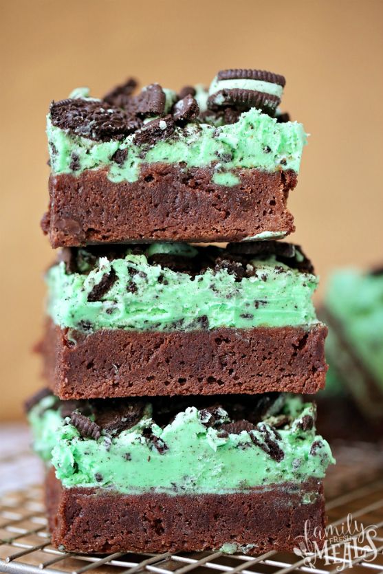 three brownies stacked on top of each other with green frosting