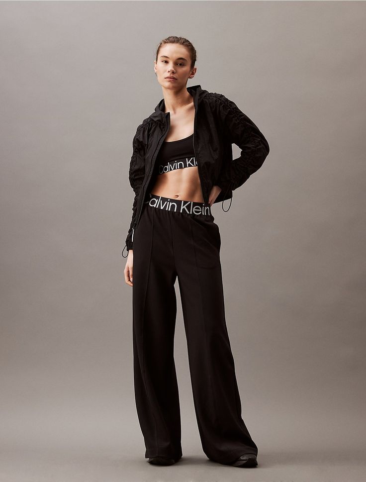 Designed with a high rise waist, these track pants feature a wide leg silhouette. Made with an elastic logo waistband and slip pockets at the sides. Styled with a patch pocket at the back and finished with seaming details along the leg for added shape.  Material: 96% Polyester, 4% Elastane. Wide Leg Track Pants, Sport Icon, Track Pants, Patch Pocket, Dream Closet, Calvin Klein, Active Wear, Wide Leg, High Rise