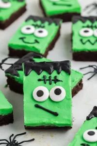 some green and black decorated cookies with eyes