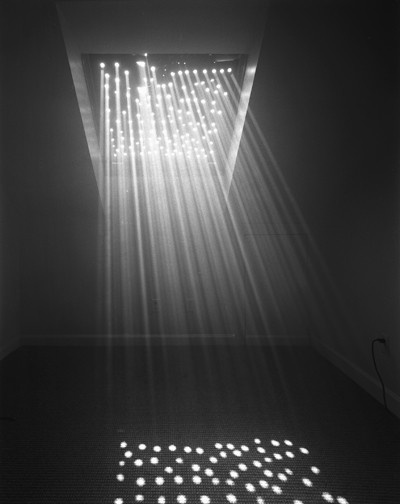 an empty room with light coming from the ceiling and lights shining down on the floor