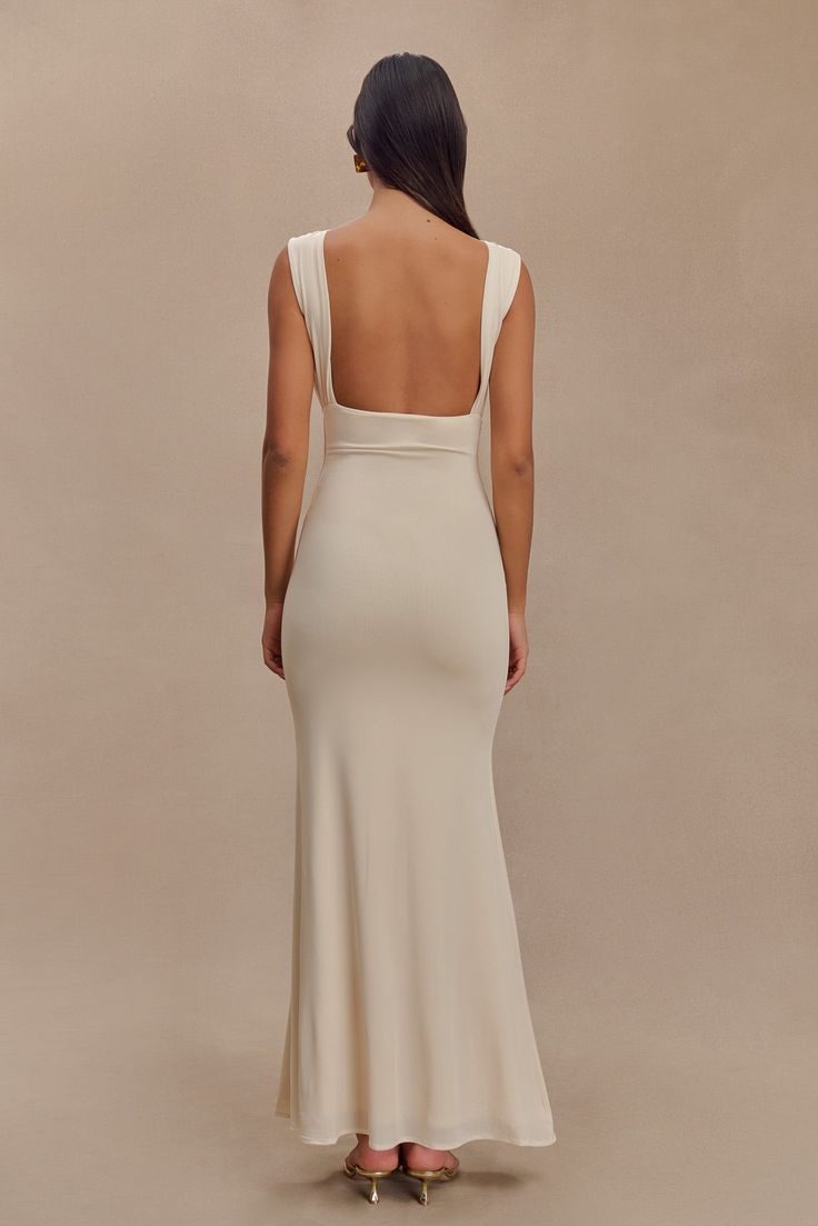 Understated glamour. The MALIA Slinky Ruched Maxi Dress is a masterclass in elegant design. Featuring a sophisticated boat neckline and daring open back, this bodycon dress flatters your silhouette with gathering detail at the bust. The fishtail hem adds a touch of drama, creating a graceful flow with every step. Fully lined for a smooth finish, Malia is the epitome of refined style. Fitted Backless Dress With Ruched Back For Formal Occasions, Elegant Fitted Backless Dress With Ruched Back, Fitted Backless Dress With Ruched Back For Gala, Elegant Stretch Dress With Closed Back, Elegant Stretch Backless Dress With Low Back, Elegant Stretch Ruched Backless Dress, Elegant Fitted Backless Dress With Ruched Bodice, Ruched Cowl Back Gala Dress, Wedding Dress With Ruched And Cowl Back