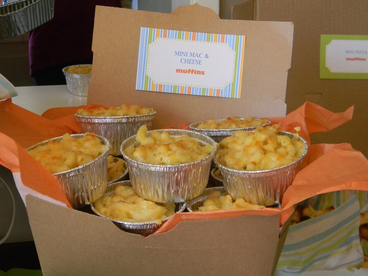 there are many muffins in tin cups on the table with an orange wrapper