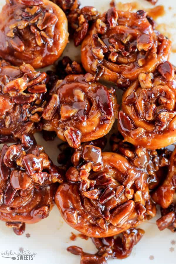 a white plate topped with lots of chocolate covered pretzel bites and caramel sauce