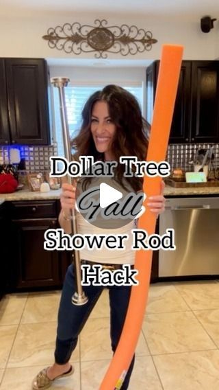 a woman holding an orange plastic tube in her hand with the words dollar tree all shower rod hack