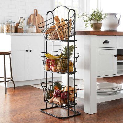 a kitchen filled with lots of food and white cupboards next to a wooden floor