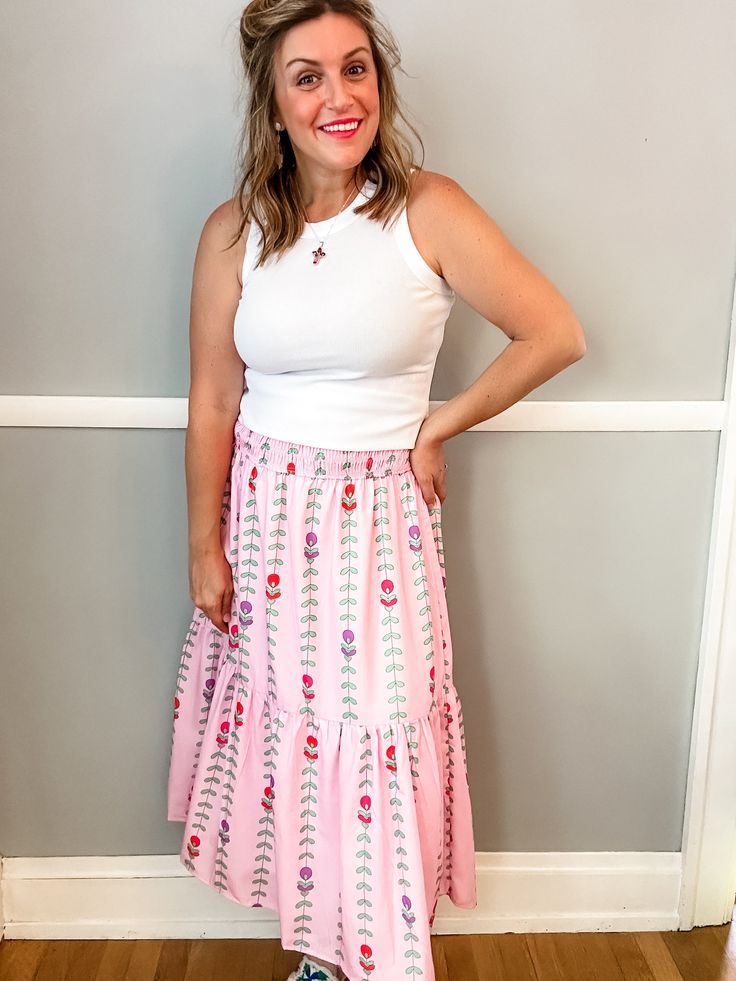 Transform your summer wardrobe with our Pink Tulip Tiered Skirt. This playful and fun piece features a stunning pattern and beautiful colors, perfect for bringing a pop of color to any outfit. With a smocked waist and lining, it not only looks great but also offers a comfortable fit. A must-have for any fashion-forward individual looking to make a statement! Fit is true to size. Emily is 5'8" wearing a medium. Small (0-4) Medium (6-8) Large (10-12) XL (14-16) Tiered Maxi Skirt For Garden Party, Feminine Tiered Maxi Skirt For Vacation, Relaxed Tiered Maxi Skirt For Garden Party, Casual Tiered Skirt For Garden Party, Casual Tiered Maxi Skirt For Garden Party, Summer Maxi Skirt With Elastic Waistband For Day Out, Casual Skirt For Garden Party, Tiered Gathered Maxi Skirt For Garden Party, Spring Tiered Skirt For Garden Party