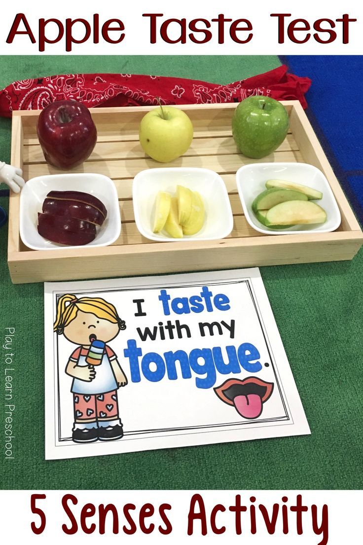 a wooden tray filled with apples and other foods