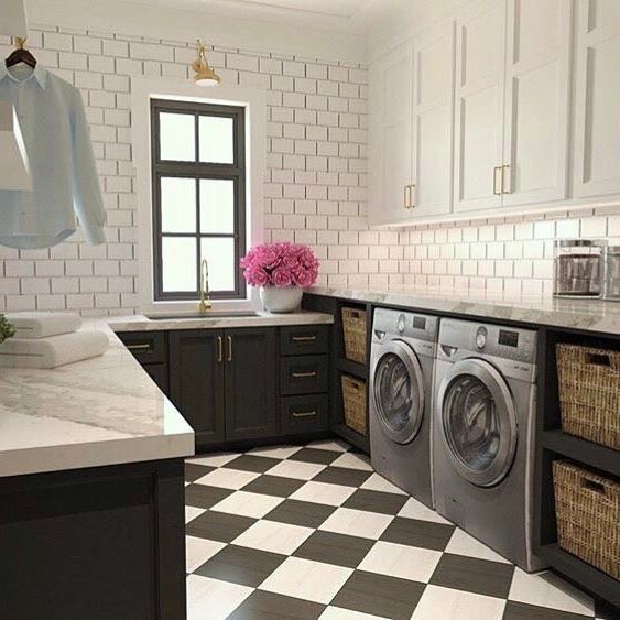 a black and white checkered floor in a kitchen with a washer and dryer