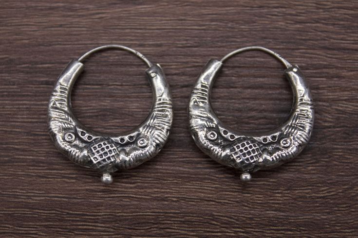 Ethnic Nepali solid pure Silver Earring-Tribal Jewelry- Ethnic Jewelry- Nepal 20th c A rare pair of small size solid pure silver earring. It has a simple design with two snakeheads. These well-made earrings are worn by women of various tribal groups for centuries. Oxidize silver, in good condition. Wt: 4g Origin: Nepal 20th c Traditional Round Engraved Earrings, Traditional Engraved Round Earrings, Traditional Silver Hoop Earrings As Gift, Traditional Silver Hoop Earrings For Gift, Round Oxidized Earrings For Ceremonial Occasions, Ceremonial Round Earrings With Oxidized Finish, Round Earrings With Oxidized Finish For Ceremonial Occasions, Traditional Sterling Silver Engraved Earrings, Traditional Engraved Round Hoop Earrings