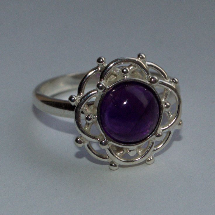 Amethyst sterling silver ring Fancy frill and bead abstract flower design sterling silver ring featuring an Amethyst gemstone. 1 x 8mm Amethyst round cabochon 925 Sterling silver UK Ring size Q/US Ring size 8 1/4 The traditional birthstone for the month of February and the gemstone for the Astrology sign of Pisces 19 February-20 March. The perfect gift for a special friend or loved one. Belonging to the quartz family, the mystical beauty of the Amethyst has been prized for thousands of years. Am Abstract Flower Design, Silver Celtic Rings, 19 February, Textured Ring, Purple Band, Abstract Flower, Cute Rings, Silver Brooch, Special Friend