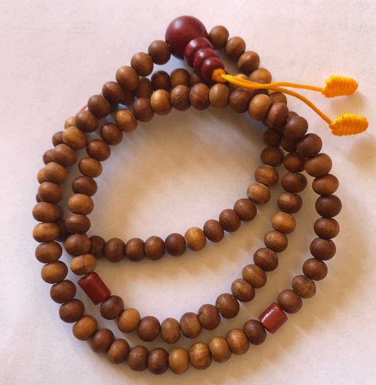 This small sandal wood mala has three traditional decoration beads and guru beads. It is from Nepal and nice and beautiful mala. it is 11 inches long mala. Spiritual Wooden Beads Mala For Meditation, Holistic Healing Mala With Wooden Beads, Handmade Wooden Beaded Bracelets For Meditation, Spiritual Wooden Beaded Bracelets, Holistic Wooden Beads Mala For Rituals, Holistic Wooden Mala For Rituals, Traditional Wooden Bracelets With Round Beads, Traditional Wooden Bracelet With Round Beads, Traditional Wood Bracelets With Round Beads