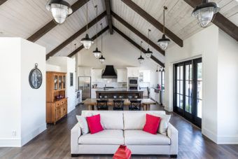 a living room filled with furniture and lots of windows