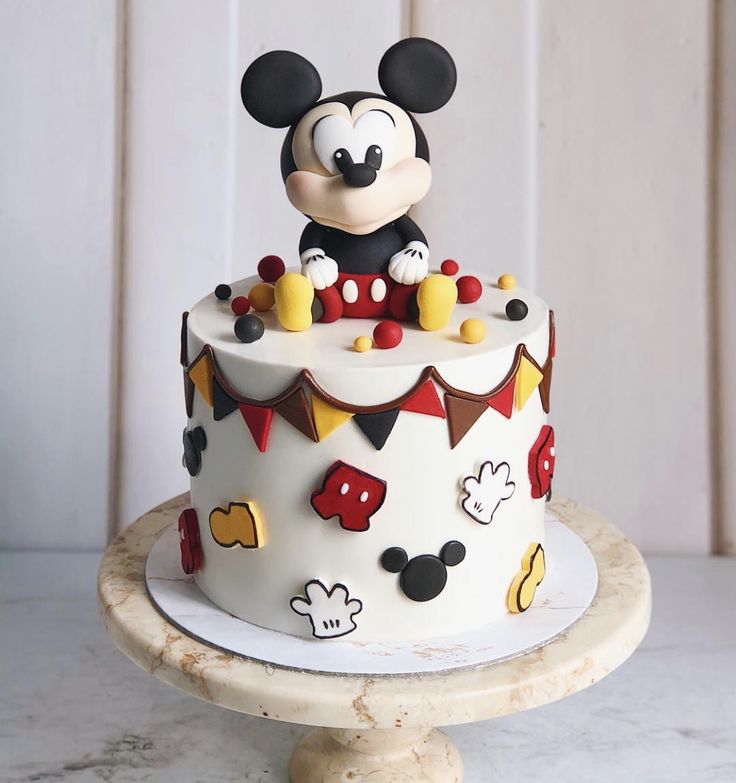 a mickey mouse birthday cake on a table