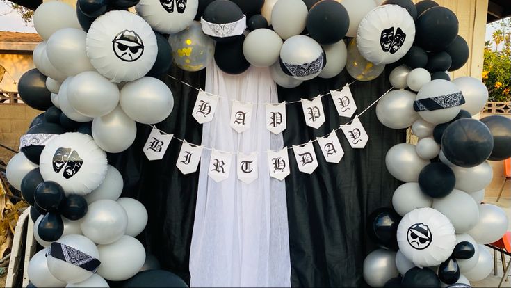 a black and white balloon arch decorated with balloons