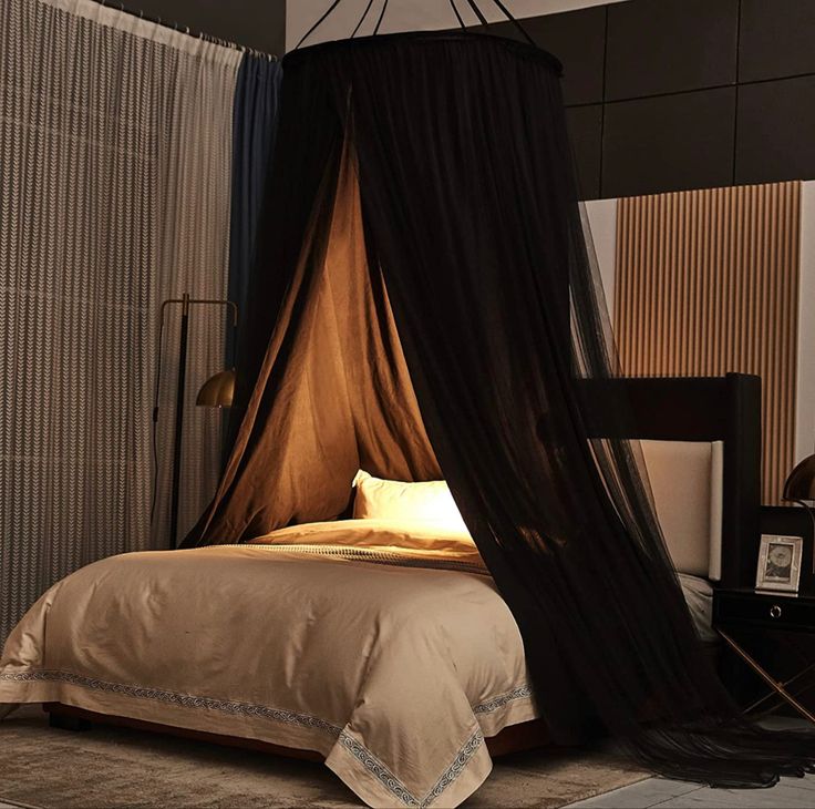 a bed with a canopy over it in a room