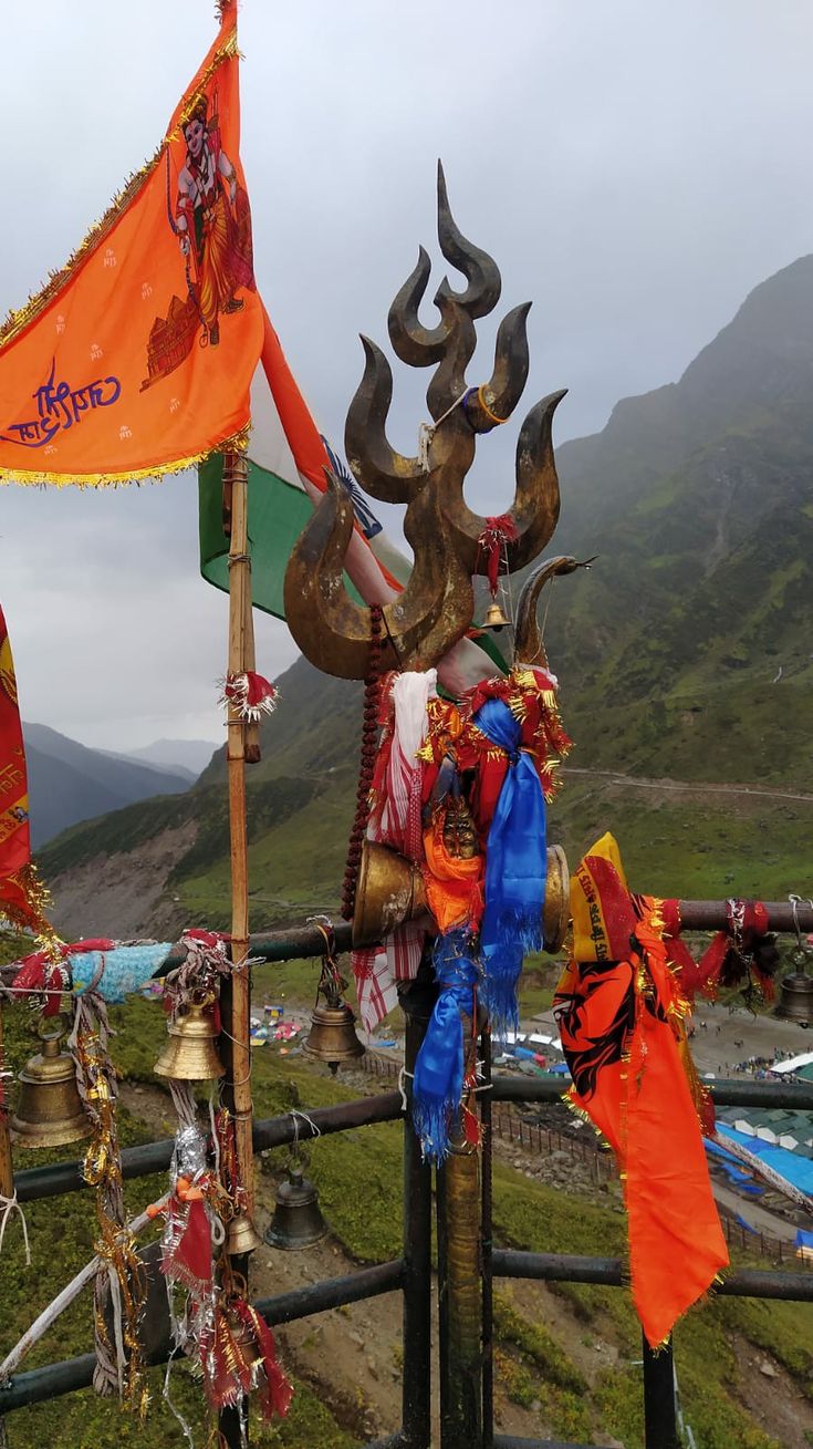 an elaborately decorated statue on the side of a road with mountains in the background