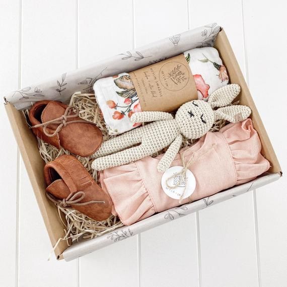 an open box filled with baby items on top of a white floor