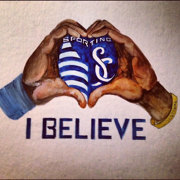 two hands holding a soccer ball with the words i believe in blue and white on it