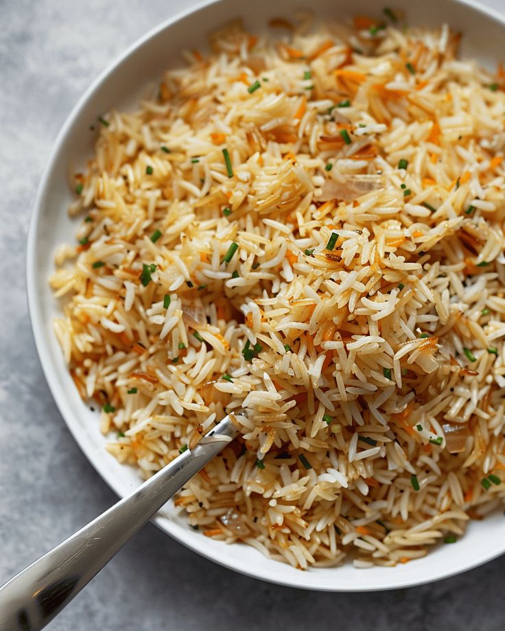 a white bowl filled with rice on top of a table