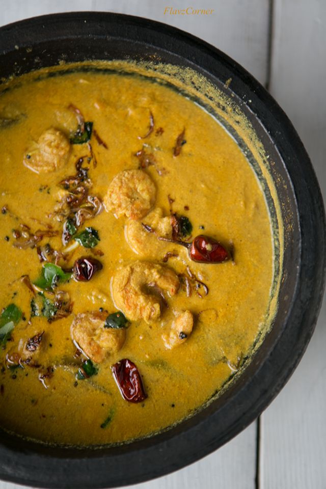 a black bowl filled with food on top of a white table