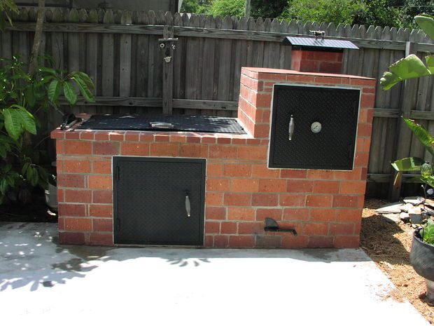 an outdoor bbq in the middle of a backyard