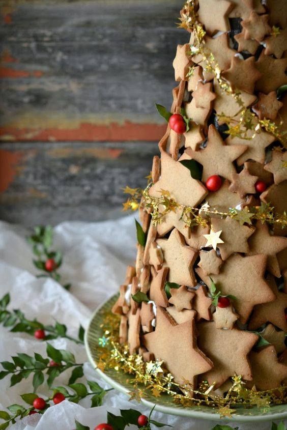 a christmas cake decorated with stars and holly